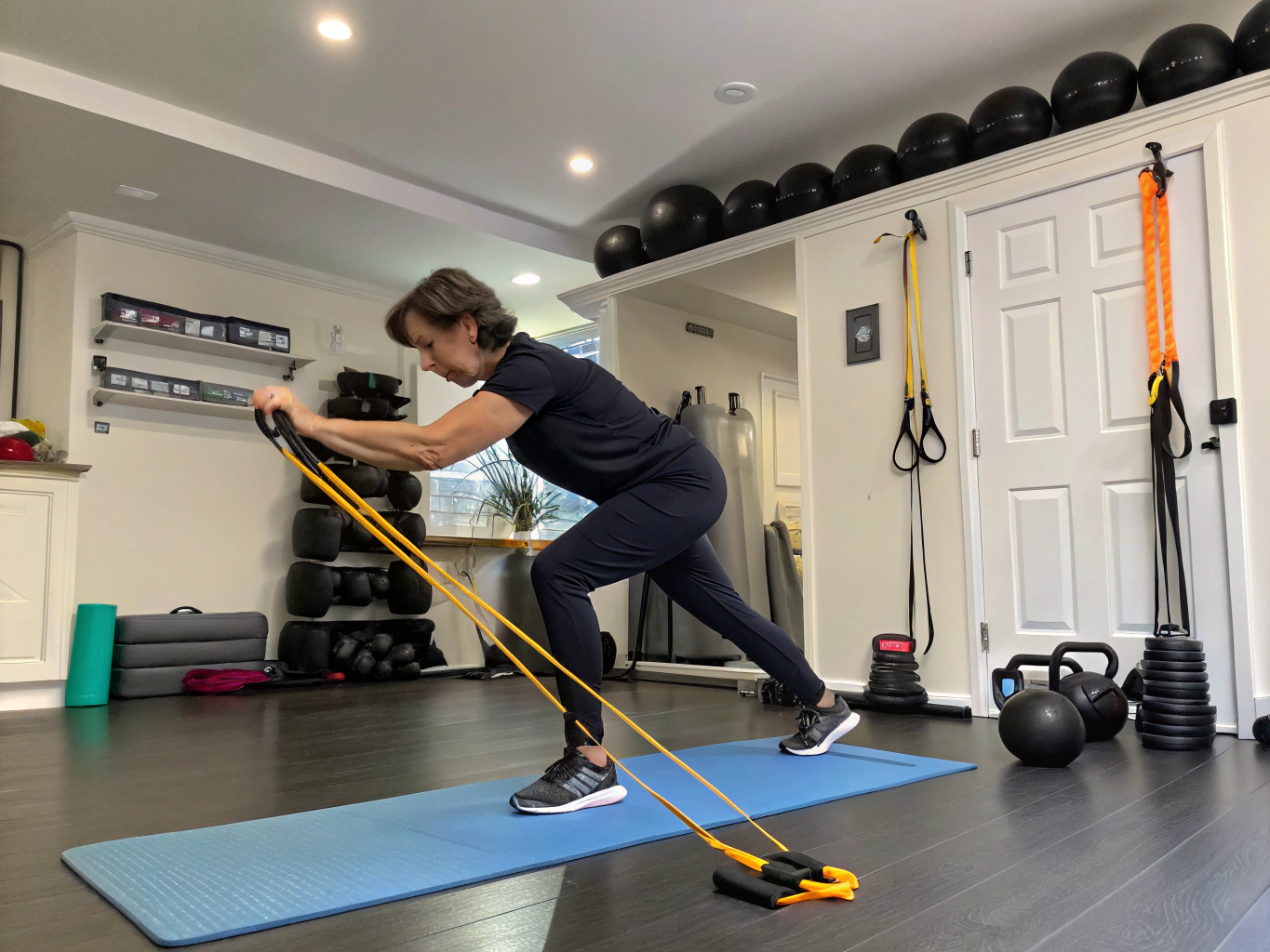 A resistance band anchored to a door frame in mid-tension during focused home training